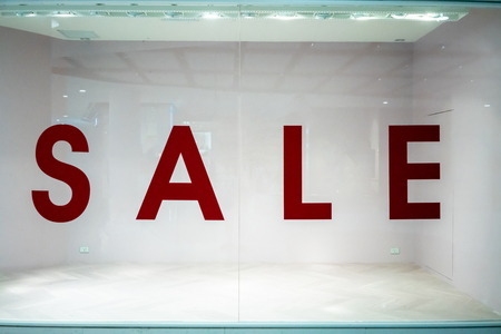 Big sale sign on empty shop window in department store.の写真素材