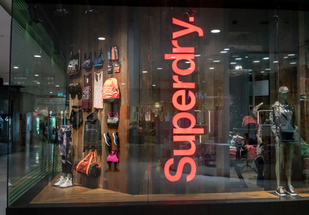 Superdry shop at Emquatier, Bangkok, Thailand, Jun 29, 2018 : Luxury and fashionable sportswear brand window display.のeditorial素材