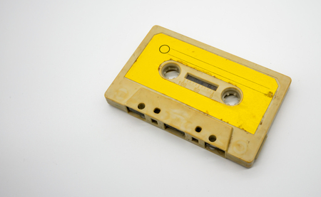 Close up of old and dirty vintage audio tape cassette isolated on white backgroundの写真素材