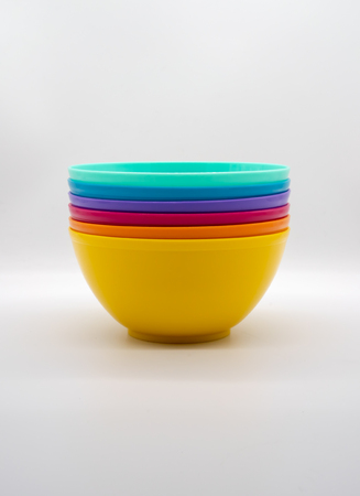 Colorful plastic bowl isolated on white backgroundの写真素材