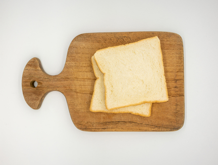 Homemade slide bread on the wooden broad on white backgroundの写真素材