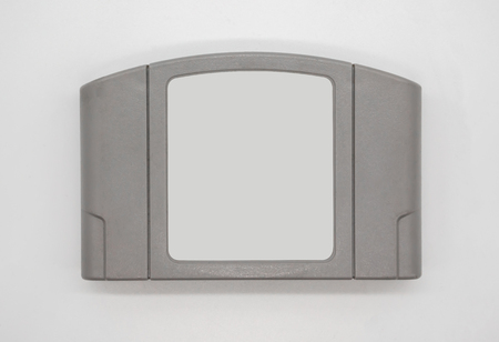 TV game cartridge in grey plastic case from 90s isolated on white background