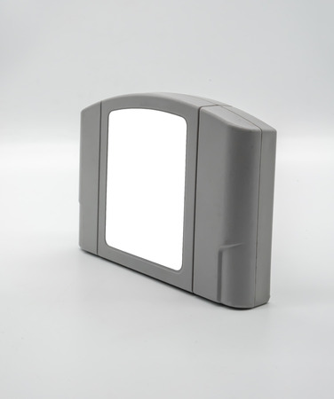 TV game cartridge in grey plastic case from 90s isolated on white background