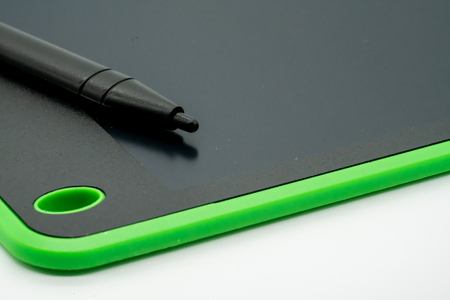 Black and green LCD writing pad tablet isolated on white backgroundの写真素材