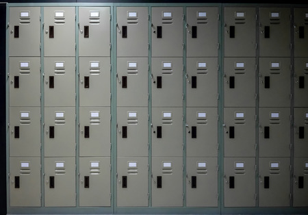 Grey metal cabinets school or gym with  handles and locks in two row