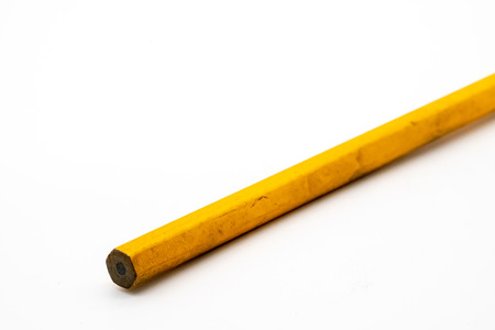 Close up on yellow pencil on white background. Selective focus.の写真素材
