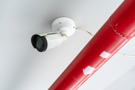 CCTV security camera installed on ceiling building. Outdoor cam for parking area.