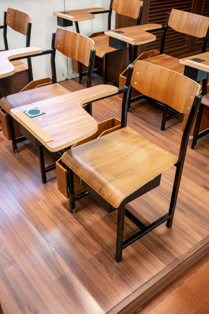 Wooden talble and chair with black speaker in vintage retro design style on wooden floor. Educational conceptの写真素材