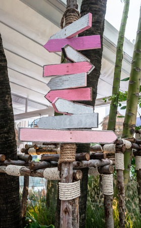 Various empty wooden signs in pink color scheme theme in public space.の写真素材