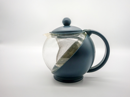 Dark bue plastic hot tea pot isolated on white background. Used tea pot.の写真素材