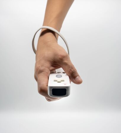 Bangkok, Thailand - Aug 19, 2018 : Wii, Hands holding the home video game controller produced by Nintendo, isolated on white background.のeditorial素材