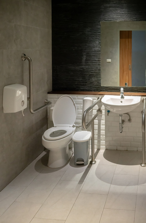 Interior of restroom for elderly senior or disability people with lavatory toilet bowl and handrail.の写真素材