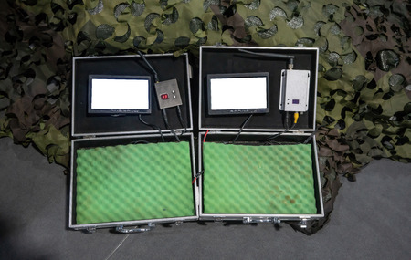 Digital display LCD monitor with digital receiver control in hard case against soldier background....