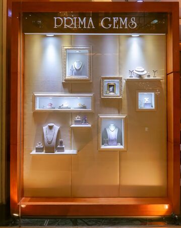 Prima Gems shop at Siam Paragon, Bangkok, Thailand, May 9, 2018 : 18K fine gold fashionable jewelry and window display in vintage style.のeditorial素材
