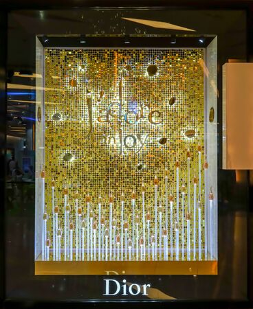 Dior shop at Siam Paragon, Bangkok, Thailand, May 9, 2018 : Jadore perfume window display with luxury look in gold.のeditorial素材