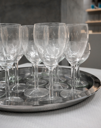 Wine glasses on silver metal tray on white texture table.の写真素材