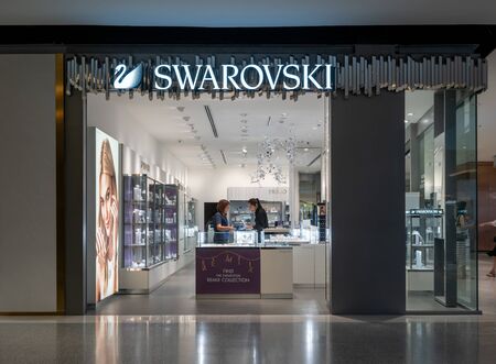 Swarovski shop at Central World, Bangkok, Thailand, Sep 2, 2018 : Autrian crystal and fashionable jewelry shop. Customer service and care in store.のeditorial素材