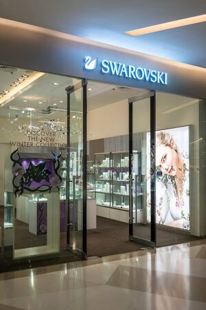 Swarovski shop at Siam Paragon, Bangkok, Thailand, Oct 19, 2018: Austrian crystal and fashionable jewelry shop. Interior and display from entrance view.のeditorial素材