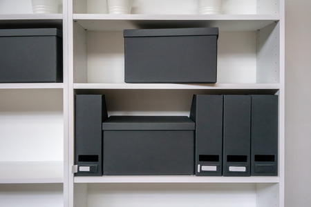 Empty paper filing box and file holder on office shelf.の写真素材