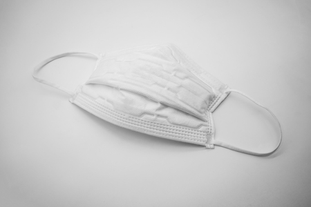 Disposable anti pollutant face mask with comfort strap isolated on white background.の写真素材