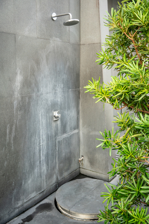 Shower outdoor in nature near swimming pool at hotel.の写真素材