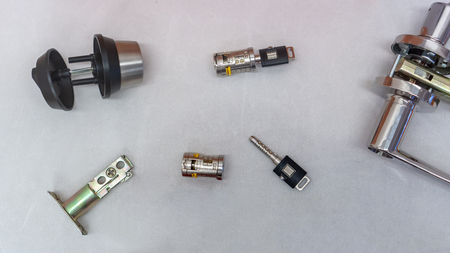 The cylinder of the lock with a pair of keys on white background. Lock with password code.
