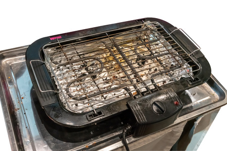 Dirty electric grill stove in metal tray in real industry kitchenの写真素材