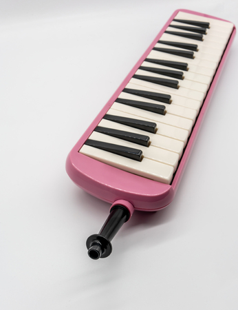Musical pink melodian isolated on white background with depth of field.の写真素材