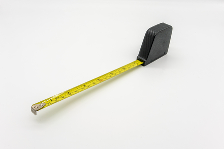 The measuring tape is isolated from the white background. Selective focus.の写真素材
