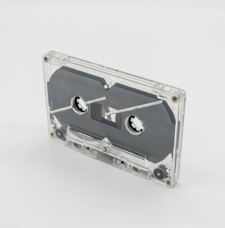Vintage clear plastic cassette tape isolated on whiteの写真素材