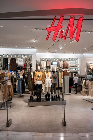 H&M shop at Emquartier, Bangkok, Thailand, Sept 20, 2019 : Standing group models in variety clothing style showcase and interior at the store.のeditorial素材