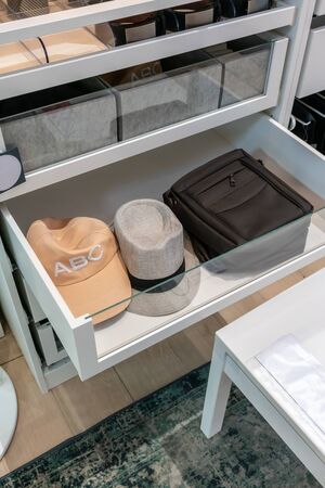 Modern drawer in closet with mens accessories inside. Interior design concept