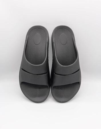 Recovery footwear in black color isolated on white background.  Foot care and wearing comfortable shoe.の写真素材