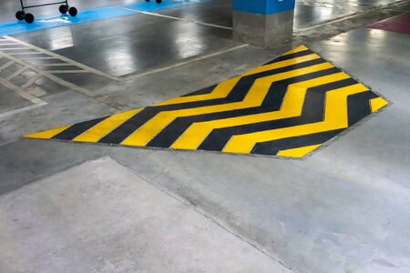 Ramped access, using wheelchair ramp with black yellow pattern on floor for disabled people.