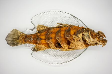 Fried fish on clear fish plate isolated on white background.