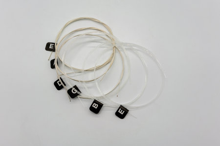 Brand-new set of nylon and metal-wound strings for classical guitar, isolated on white backgroundの写真素材