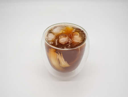 Iced coconut coffee in double walls glass isolated on white background. Selective focus.の写真素材