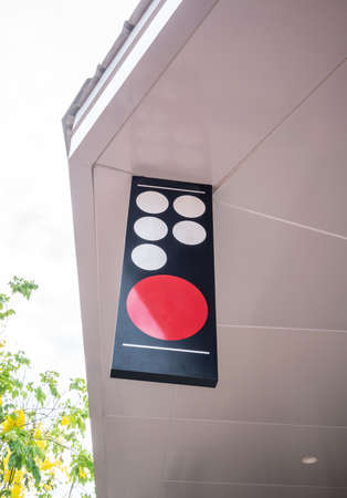 Blank outdoor sign hanging from white ceiling in front of shop or restaurant. Mock up signage.