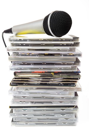 Microphone and karaoke compact disc collection on white backgroundの写真素材