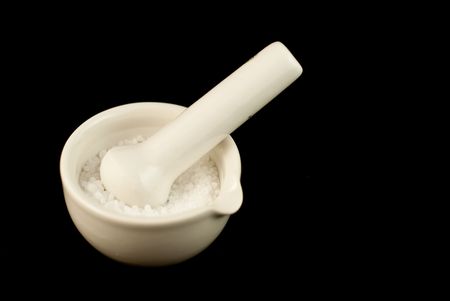 Salt in mortar. Shot against black backgroundの写真素材