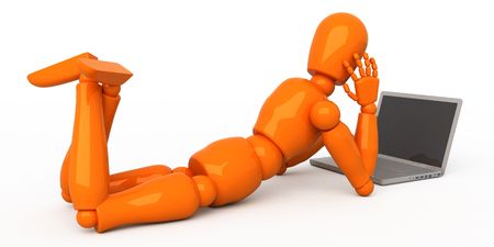 Orange mannequin with laptopの写真素材