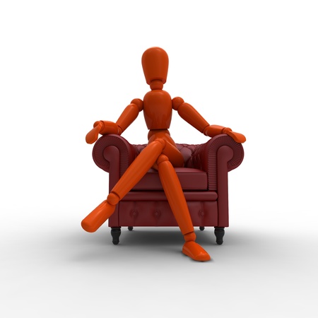 Orange mannequin is sitting in a red leather armchair.の写真素材