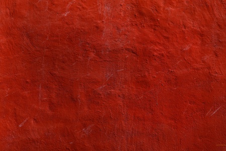 Red bulged cracked surface of rough plaster / backdropの写真素材