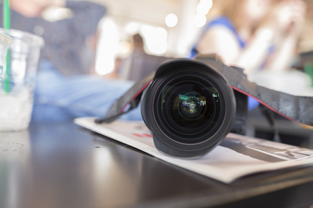 Lens and camera on table,with filter blurの写真素材
