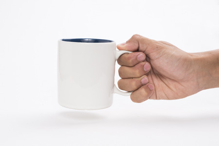 hand holding a mug isolated on white backgroundの写真素材