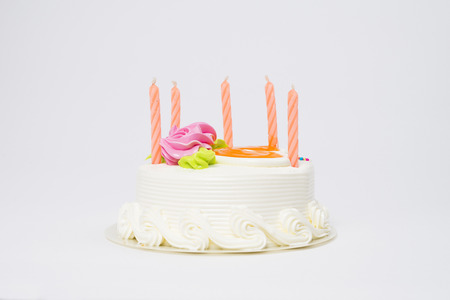 Birthday cake with candles  isolated on white backgroundの写真素材