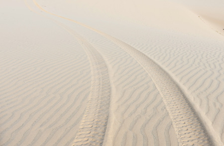 trace of wheels on the sandの写真素材