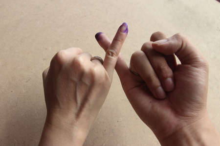 Magelang, Indonesia - December 9, 2020 : 
finger inked as evidence has done the vote for local election with health protocols during the Covid-19 pandemicのeditorial素材