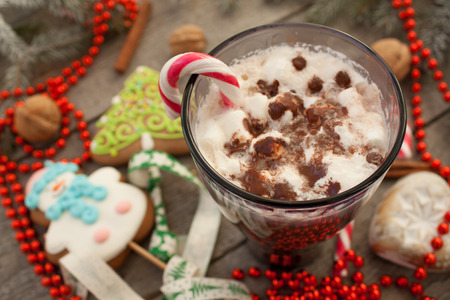 christmas background, composition. spruce branches, gingerbread (Snowman and Christmas tree), cocoa with cream and marshmallows, cinnamon, candy cane.の写真素材