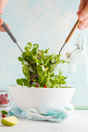 Stirring bright diet green salad. Healthy Dietary Vegetarian Food Concept.の写真素材